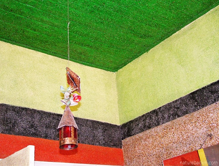 Painted ceiling and walls encrusted with glass, and decorated lamp, Owl House, South Africa